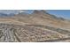 Scenic aerial of a neighborhood set against a dramatic mountain backdrop at 2194 Pigeon Hawk St, Las Vegas, NV 89138