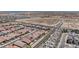 High angle shot featuring rows of homes and streets with the city skyline in the distance at 2194 Pigeon Hawk St, Las Vegas, NV 89138