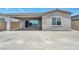 Rear exterior view of house featuring covered patio with tile flooring, and a large gravel yard at 2194 Pigeon Hawk St, Las Vegas, NV 89138
