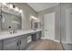 Modern bathroom with double vanity, walk-in shower, and sleek gray cabinets at 2194 Pigeon Hawk St, Las Vegas, NV 89138
