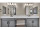 Bathroom vanity featuring double sinks, white countertops, modern black fixtures, and stylish mirrors at 2194 Pigeon Hawk St, Las Vegas, NV 89138