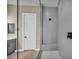 Modern bathroom featuring a frameless glass shower with gray textured tiling and a small bench at 2194 Pigeon Hawk St, Las Vegas, NV 89138