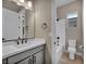 Bathroom featuring a white quartz countertop, dark cabinets, and a tub at 2194 Pigeon Hawk St, Las Vegas, NV 89138
