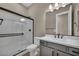 Modern bathroom with white shower, sleek fixtures, stylish vanity, and a convenient toilet at 2194 Pigeon Hawk St, Las Vegas, NV 89138
