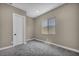 Bedroom featuring gray carpet, a window, and neutral colored walls, creating a cozy space at 2194 Pigeon Hawk St, Las Vegas, NV 89138