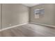 This bedroom features neutral walls, wood flooring, a window for natural light, and a minimalist modern design at 2194 Pigeon Hawk St, Las Vegas, NV 89138