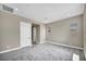 Bedroom with carpet flooring and a neutral paint, features two doors and natural lighting at 2194 Pigeon Hawk St, Las Vegas, NV 89138