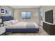 This bedroom features a beautiful window view, a comfortable bed, and a modern entertainment center at 2194 Pigeon Hawk St, Las Vegas, NV 89138