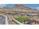 A well-maintained community park with a green lawn, pergola, and desert landscaping at 2194 Pigeon Hawk St, Las Vegas, NV 89138
