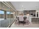 Bright dining area featuring a modern chandelier, backyard view, and gray kitchen with stainless steel appliances at 2194 Pigeon Hawk St, Las Vegas, NV 89138