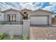 Inviting exterior of a single-story home with a brick driveway and stone accents adding to its architectural charm at 2194 Pigeon Hawk St, Las Vegas, NV 89138