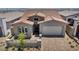 Single-story home with a two-car garage, stone accents, and desert landscaping at 2194 Pigeon Hawk St, Las Vegas, NV 89138