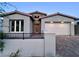 Charming single-story home with a well-manicured front yard, brick driveway, and two-car garage at 2194 Pigeon Hawk St, Las Vegas, NV 89138