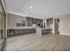 Open kitchen with gray cabinets, stainless steel appliances, and island with quartz countertop at 2194 Pigeon Hawk St, Las Vegas, NV 89138