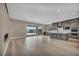 Modern gray kitchen with a central island, stainless appliances, and a sliding door to a patio at 2194 Pigeon Hawk St, Las Vegas, NV 89138