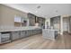 Spacious kitchen featuring gray cabinets, island, modern stainless steel appliances, and light hardwood floors at 2194 Pigeon Hawk St, Las Vegas, NV 89138