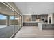 Spacious kitchen featuring gray cabinets, stainless steel appliances, island and large sliding glass doors at 2194 Pigeon Hawk St, Las Vegas, NV 89138