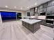 Open-concept kitchen with a large island, modern appliances, and sliding glass doors to the outside at 2194 Pigeon Hawk St, Las Vegas, NV 89138