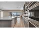 Gourmet kitchen boasts gray cabinets, stainless steel appliances, double oven, island, and mountain view at 2194 Pigeon Hawk St, Las Vegas, NV 89138