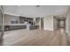 Spacious open floor plan with a modern gray kitchen, central island, and hardwood flooring at 2194 Pigeon Hawk St, Las Vegas, NV 89138