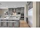 Modern kitchen with a large island, breakfast bar seating, gray cabinets, and stainless steel appliances at 2194 Pigeon Hawk St, Las Vegas, NV 89138