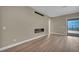 This home's living area features a sleek fireplace, wood floors, and access to an outdoor space at 2194 Pigeon Hawk St, Las Vegas, NV 89138