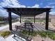 Community pergola with picnic tables, seating, and landscaping at 2194 Pigeon Hawk St, Las Vegas, NV 89138