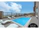 Virtually staged backyard features a sparkling pool, lounge chairs, and an outdoor seating area with views at 2194 Pigeon Hawk St, Las Vegas, NV 89138