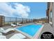Virtually staged backyard features a sparkling pool, lounge chairs, and an outdoor seating area with views at 2194 Pigeon Hawk St, Las Vegas, NV 89138