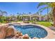 Stunning backyard with a custom pool, lounge chairs, and lush landscaping at 2201 Country Cottage Ct, Las Vegas, NV 89117