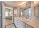 Well-lit bathroom featuring double sinks, neutral colors, and access to the bedroom at 2201 Country Cottage Ct, Las Vegas, NV 89117