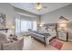 Cozy bedroom with sitting area, neutral colors, and a large bay window at 2201 Country Cottage Ct, Las Vegas, NV 89117