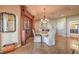 Elegant dining room boasts travertine floors, decorative lighting, and a temperature-controlled wine closet at 2201 Country Cottage Ct, Las Vegas, NV 89117