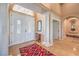 Inviting foyer with double doors, tile flooring, decorative rug, a pillar and arched doorways leading to other rooms at 2201 Country Cottage Ct, Las Vegas, NV 89117