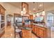 Gourmet kitchen with custom cabinetry, granite countertops, and a large center island with seating at 2201 Country Cottage Ct, Las Vegas, NV 89117