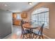 Charming eat-in kitchen with a dining table next to large windows and modern stainless steel appliances at 2201 Country Cottage Ct, Las Vegas, NV 89117