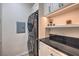 Well-organized laundry room with modern washer/dryer, granite countertops, and ample storage at 2201 Country Cottage Ct, Las Vegas, NV 89117
