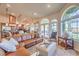 Open concept living room with hardwood floors and large arched windows with backyard views at 2201 Country Cottage Ct, Las Vegas, NV 89117