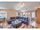 Spacious living room with large sectional, wood floors, natural light, and double door entry at 2201 Country Cottage Ct, Las Vegas, NV 89117