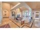 Spacious living room with tile floors, fireplace, elegant furnishings, and natural light from large windows at 2201 Country Cottage Ct, Las Vegas, NV 89117
