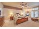 Spacious main bedroom boasts a fireplace, ceiling fan, and light-filled windows with shutters at 2201 Country Cottage Ct, Las Vegas, NV 89117