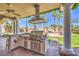 Outdoor kitchen complete with a built-in grill, perfect for entertaining near the pool at 2201 Country Cottage Ct, Las Vegas, NV 89117