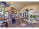 Covered patio features an outdoor fireplace and ample seating for entertaining at 2201 Country Cottage Ct, Las Vegas, NV 89117