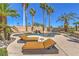 Backyard pool with lounge chairs and rock waterfall feature with mature palm trees at 2201 Country Cottage Ct, Las Vegas, NV 89117