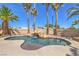 Backyard pool area with a custom waterfall feature surrounded by lush landscaping at 2201 Country Cottage Ct, Las Vegas, NV 89117