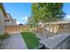 A serene backyard features artificial grass, mature trees, and a paved walkway at 234 Polaris Ridge Ave, Henderson, NV 89011