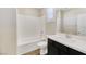Stylish bathroom featuring a bathtub, shower, and modern fixtures, complete with dark cabinetry at 234 Polaris Ridge Ave, Henderson, NV 89011