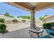 The backyard features a covered patio area with stone columns, rock landscaping, and mature greenery at 2545 Banora Point Dr, Las Vegas, NV 89134