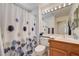 Well-lit bathroom features a shower-tub combo with a blue flower shower curtain and updated vanity at 2545 Banora Point Dr, Las Vegas, NV 89134