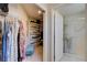 Bright walk-in closet featuring shelving, clothing racks, and a soft blue ottoman for added convenience at 2545 Banora Point Dr, Las Vegas, NV 89134